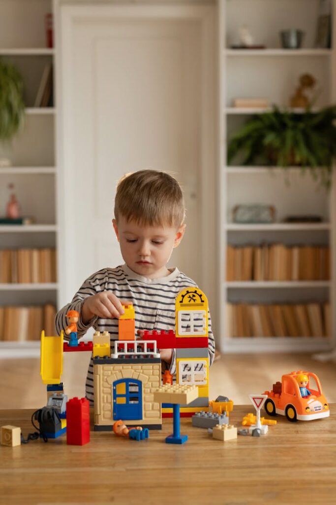 A young boy playing with a toy construction set